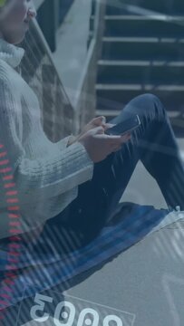 Vertical video: Girl sitting on steps tapping phone, browsing for tech while overlays crossing her