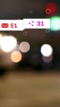 Vertical video: Walker crossing night bokeh, causing mail badge and like counts updating for ads