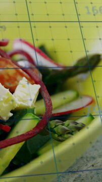 Vertical video: Shot zooming in showing beet spirals, feta under grid numbers for food styling