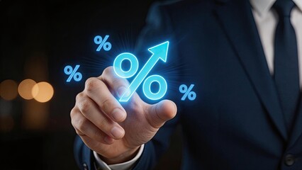 Fototapeta premium Businessman touching a glowing blue digital interface with a percentage symbol and an upward arrow representing financial growth investment success and economic progress in a