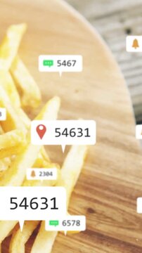 Vertical video: Camera panning revealing board with burger, fries and floating UI badges for ads