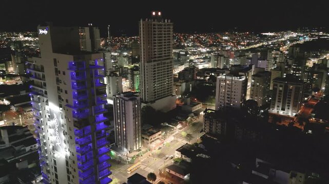 Nighttime drone footage of buildings in downtown Chapec&oacute;.