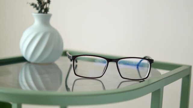 Glasses resting on a table in a simple room setting