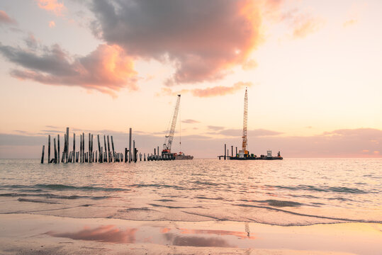 Floating construction equipment in place to rebuild Naples Pier that was destroyed by Hurricane Ian in Florida in 2022