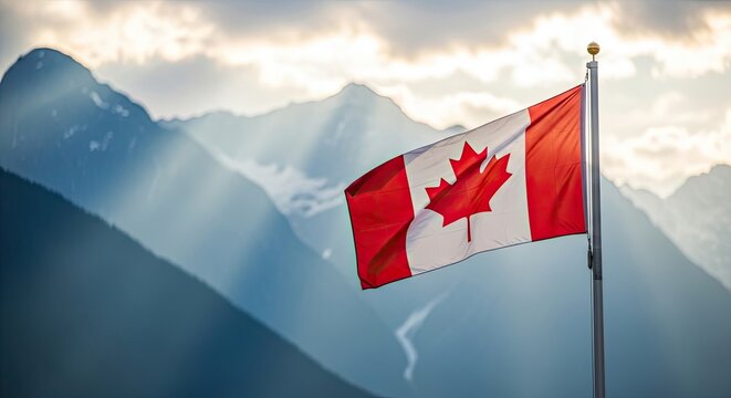 Canadian flag waving against a majestic mountain landscape