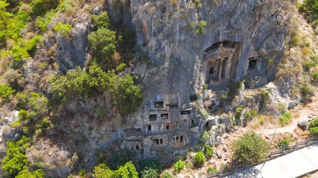 Fethiye, Turkey. Archaeological site of ancient Telmessos with detailed Lycian rock cut tombs in the rocky slope, aerial drone perspective.. Aerial View, Point of interest