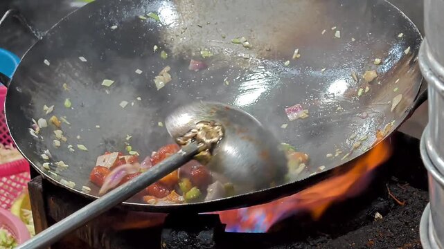 Street food vendor preparing delicious veg manchurian. Popular indo chinese street food