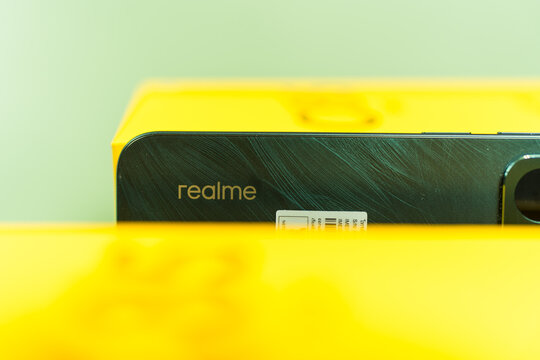 Bangkok, Thailand - April 7, 2026 : Selective focus logo realme on Peacock Green smartphone of Realme C85 5G