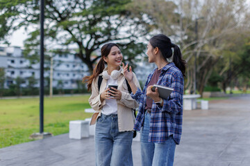 Fototapeta premium College students walking and talking on university campus