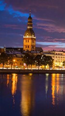 Fototapeta premium A serene cityscape at dusk with a large building and calm water