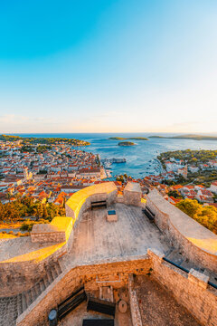 Stunning sunset over Hvar town and Pakleni Islands viewed from the medieval Spanish Fortress, golden hour over the Adriatic sea, Croatia.