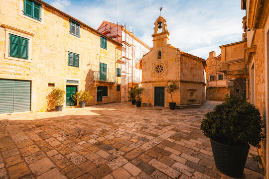 Jelsa town on Hvar island, with traditional Dalmatian stone architecture and boats moored in the harbor, Croatia.