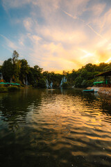 Fototapeta premium Kravice Waterfalls on the Trebižat River, a natural amphitheater of cascading water and lush green nature near Ljubuški, Bosnia and Herzegovina.