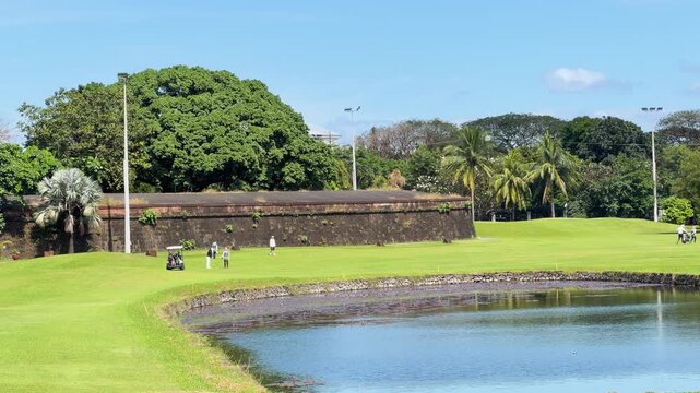 Golfer Putting on Green at Club Intramuros in Manila Philippines