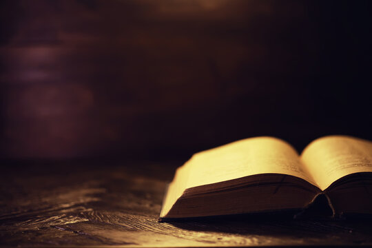 Book on a wooden table background with copy space. Historical atmosphere. Vintage english style. Evidence searching concept. Empty place for text.