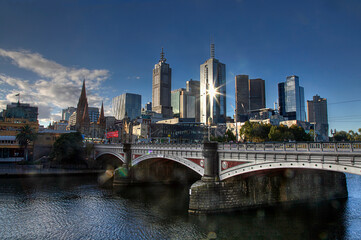 Fototapeta premium Melbourne cityscape with bridge and modern skyscrapers under clear sky