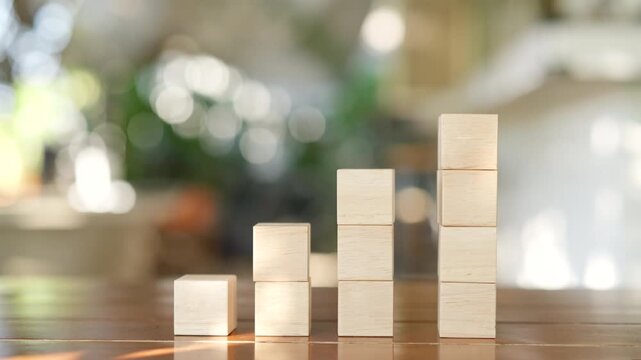 Hand arranging wooden blocks in staircase shape for business growth, financial investment strategy and successful development concept step by step.