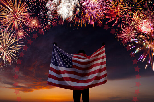 National flag of United States of America in sky with fireworks independence day