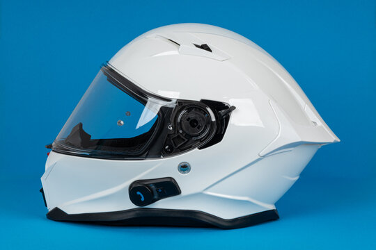 White motorcycle carbon integral crash helmet on blue white. High quality motorcycle helmet