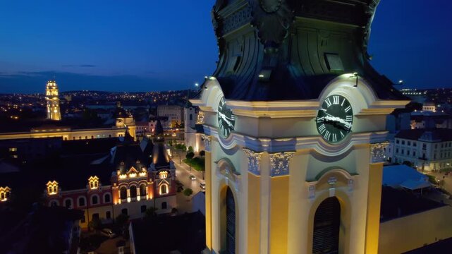 Night aerial view of Oradea city hall and central uniri square with illuminated baroque architecture.
