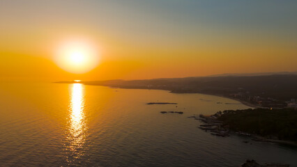 Obraz premium Avsallar, Alanya, Turkey. Panoramic aerial view of coastal city, shoreline and Mediterranean Sea at sunset.. Aerial View