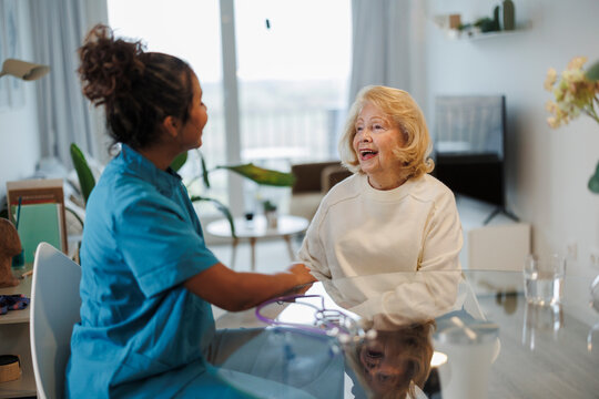 Home healthcare nurse assisting with medical checkup and consultation