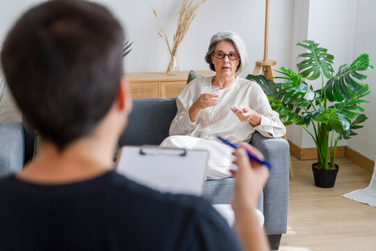 Consultation and therapy session on sofa in cozy living room