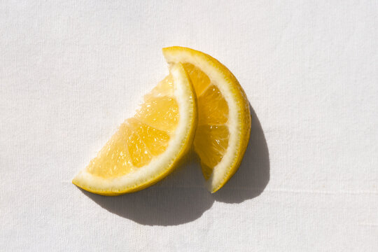 Two fresh lemon slices in natural light with clean minimal composition