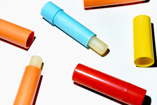 Colorful lip balm tubes on white background in studio shot