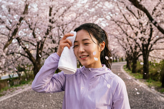 AI generated, AI person, woman, 20s, cherry blossom running