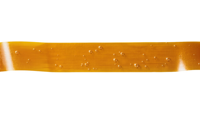 Amber resinous sticky tape with air bubbles, isolated on transparent background