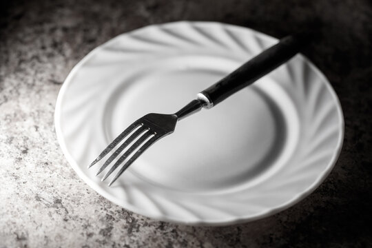 A fork is on a white plate