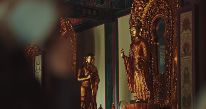Golden Buddhist statue inside Yonghe Lama Temple