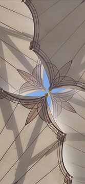 Ornately designed large umbrellas at Al-Masjid an-Nabawi, Medina, Saudi Arabia, feature geometric patterns. Made from durable fabric, they provide shelter and shade. The umbrellas are mounted on tall,