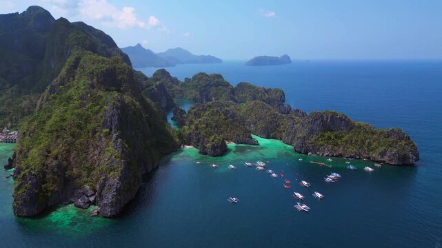 Big Lagoon in El Nido, Palawan showing limestone islands, clear turquoise water, and scenic ocean views. Breathtaking aerial view drone shot panorama from above