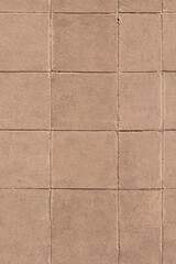 Fototapeta premium Beige stone tiles forming a clean outdoor pavement surface