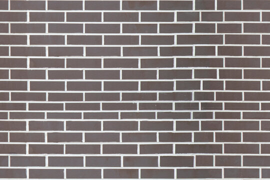 Brown brick wall background with gray mortar in outdoor setting