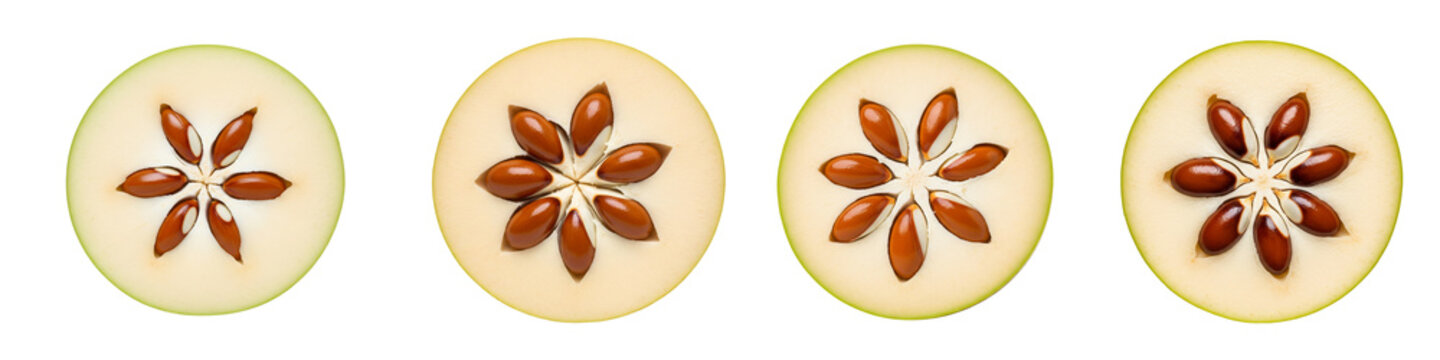 Four slices of fresh star apple fruit isolated on black background