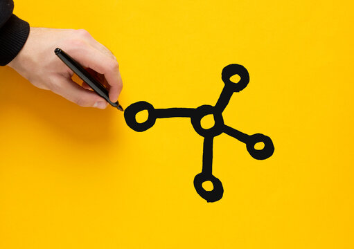 Hand drawing network on yellow background with black marker