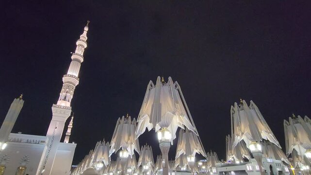 Nabawi mosque tower decorated with umbrellas closed in the night