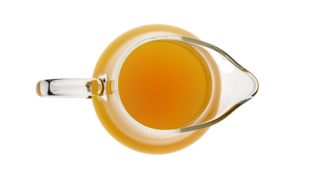Clear glass pitcher with amber liquid, isolated on transparent background