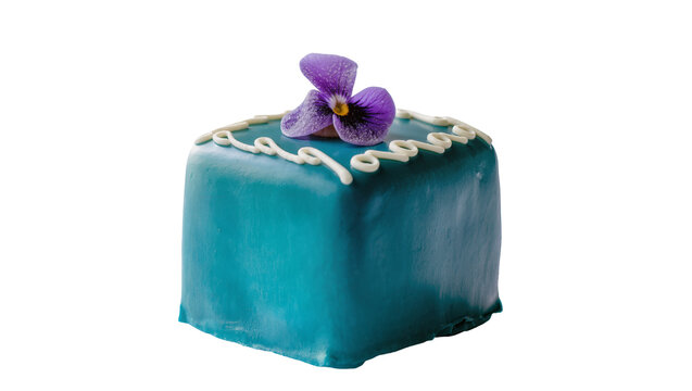 Teal frosted petit four cake with white icing swirls and purple flower, isolated on transparent background