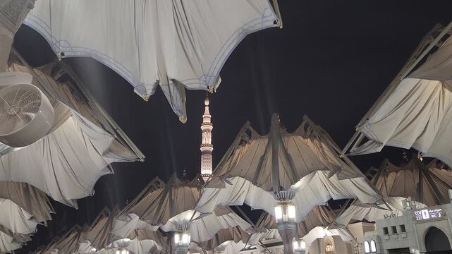 Nabawi mosque tower decorated with umbrellas closed in the night
