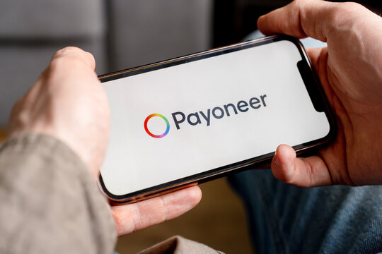 A man holds a smartphone with the Payoneer app. Saint Petersburg, Russia - 7 Apr 2026