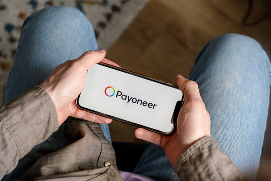 A man holds a smartphone with the Payoneer app. Saint Petersburg, Russia - 7 Apr 2026