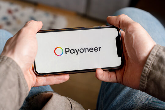 A man holds a smartphone with the Payoneer app. Saint Petersburg, Russia - 7 Apr 2026