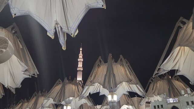 Nabawi mosque tower decorated with umbrellas closed in the night