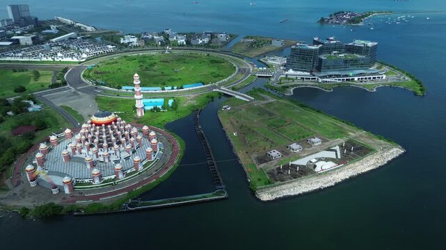Aerial Coastal View of 99 Domes Mosque in Makassar by Losari Waterfront with CPI makassar as background, masjid kubah 99 makassar.