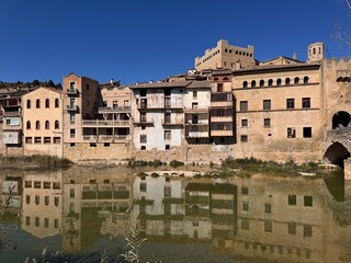 Fototapeta premium Historic town skyline with river reflection and castle in Valderrobres Teruel Spain