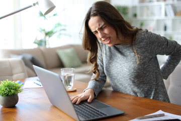 Stressed tele worker suffering back ache on uncomfortable chair